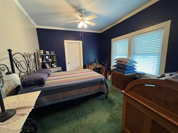 a bedroom with two beds and a chandelier