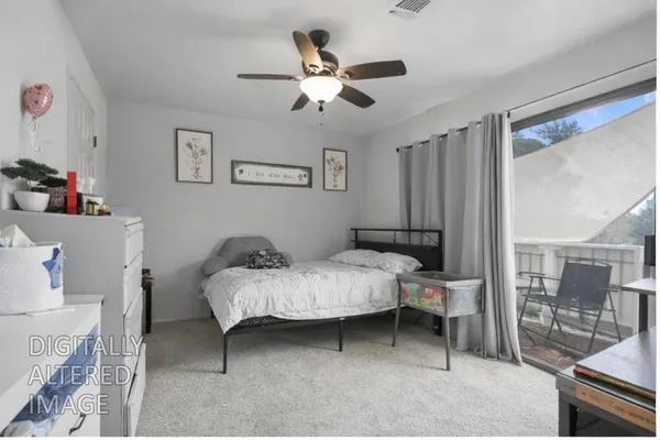 a bed room with a bed and a chair