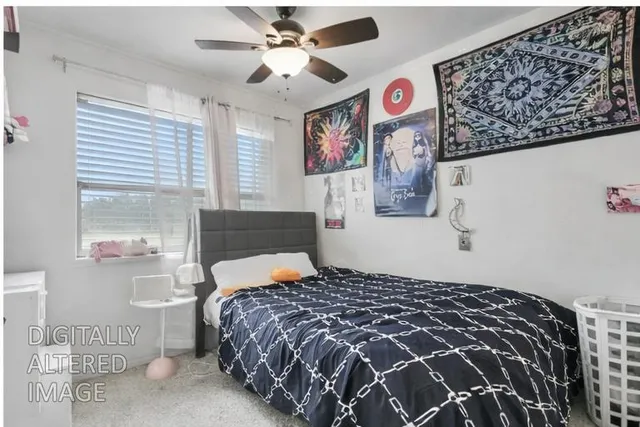 a bedroom with a bed and painting on the wall