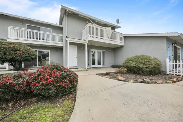 a front view of a house with garden