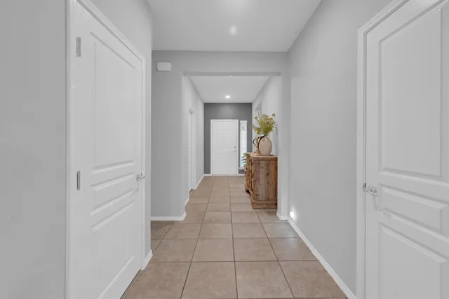 a view of a hallway with a livingroom and a bathroom