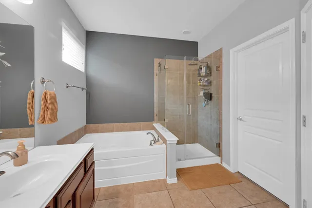 a bathroom with a tub sink and a mirror