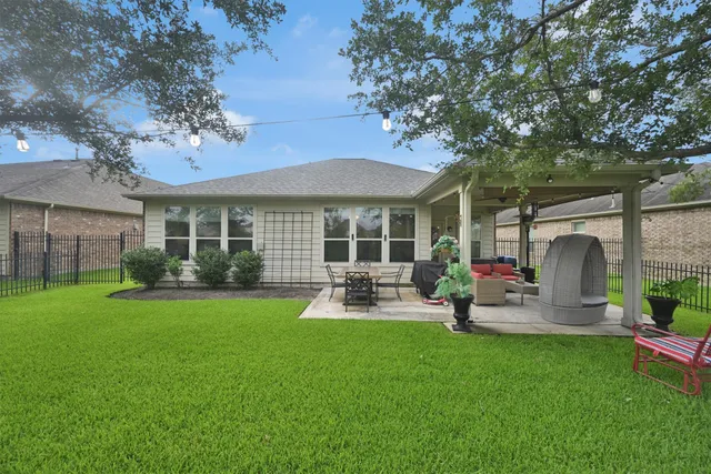 a view of a house with backyard porch and sitting area