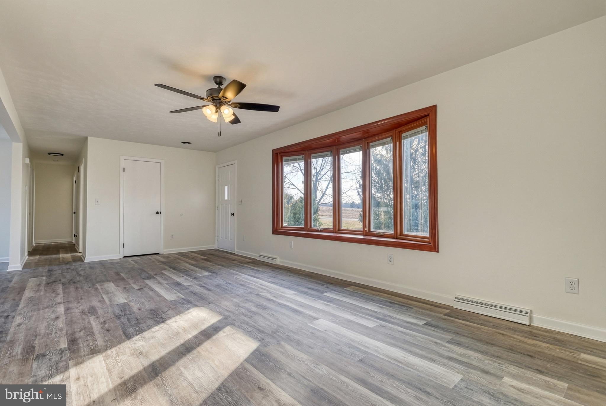79 North School House Road Thomasville, PA 17364 - Photo 11 of 73 a view of empty room with wooden floor and fan