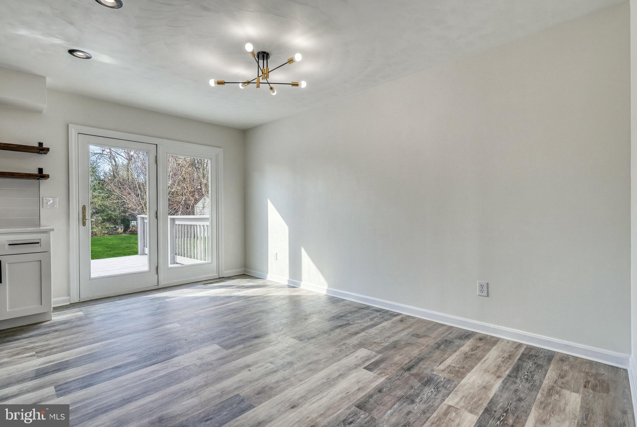 79 North School House Road Thomasville, PA 17364 - Photo 19 of 73 a view of an empty room with a window and wooden floor