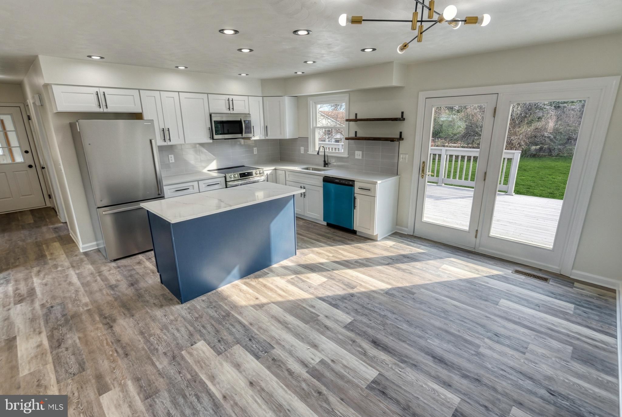 79 North School House Road Thomasville, PA 17364 - Photo 21 of 73 a kitchen with stainless steel appliances granite countertop a refrigerator a sink dishwasher a stove and white countertops with wooden floor