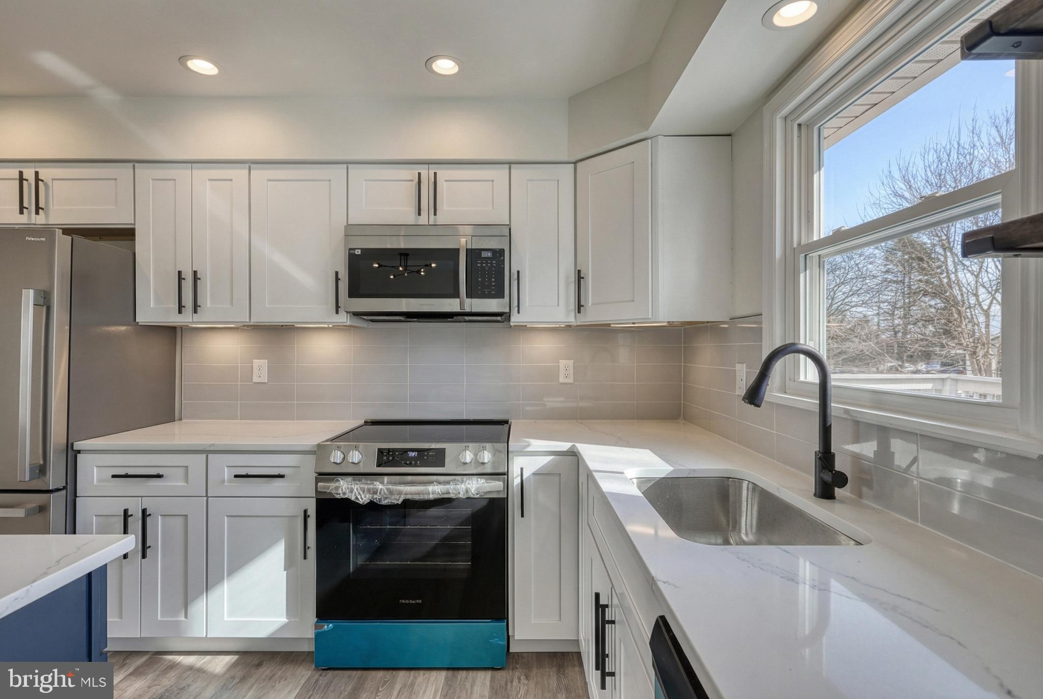 79 North School House Road Thomasville, PA 17364 - Photo 23 of 73 a kitchen with stainless steel appliances granite countertop a stove a sink and a microwave