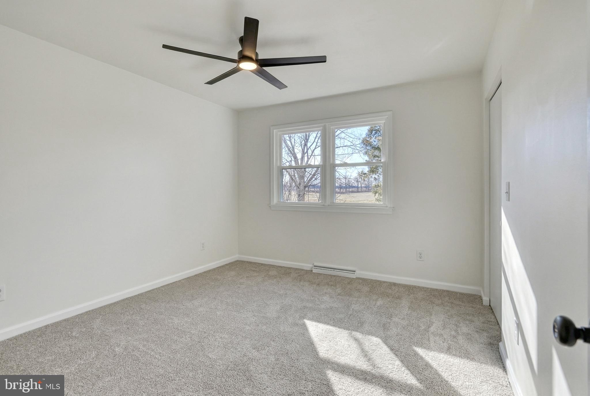 79 North School House Road Thomasville, PA 17364 - Photo 28 of 73 an empty room with windows and fan