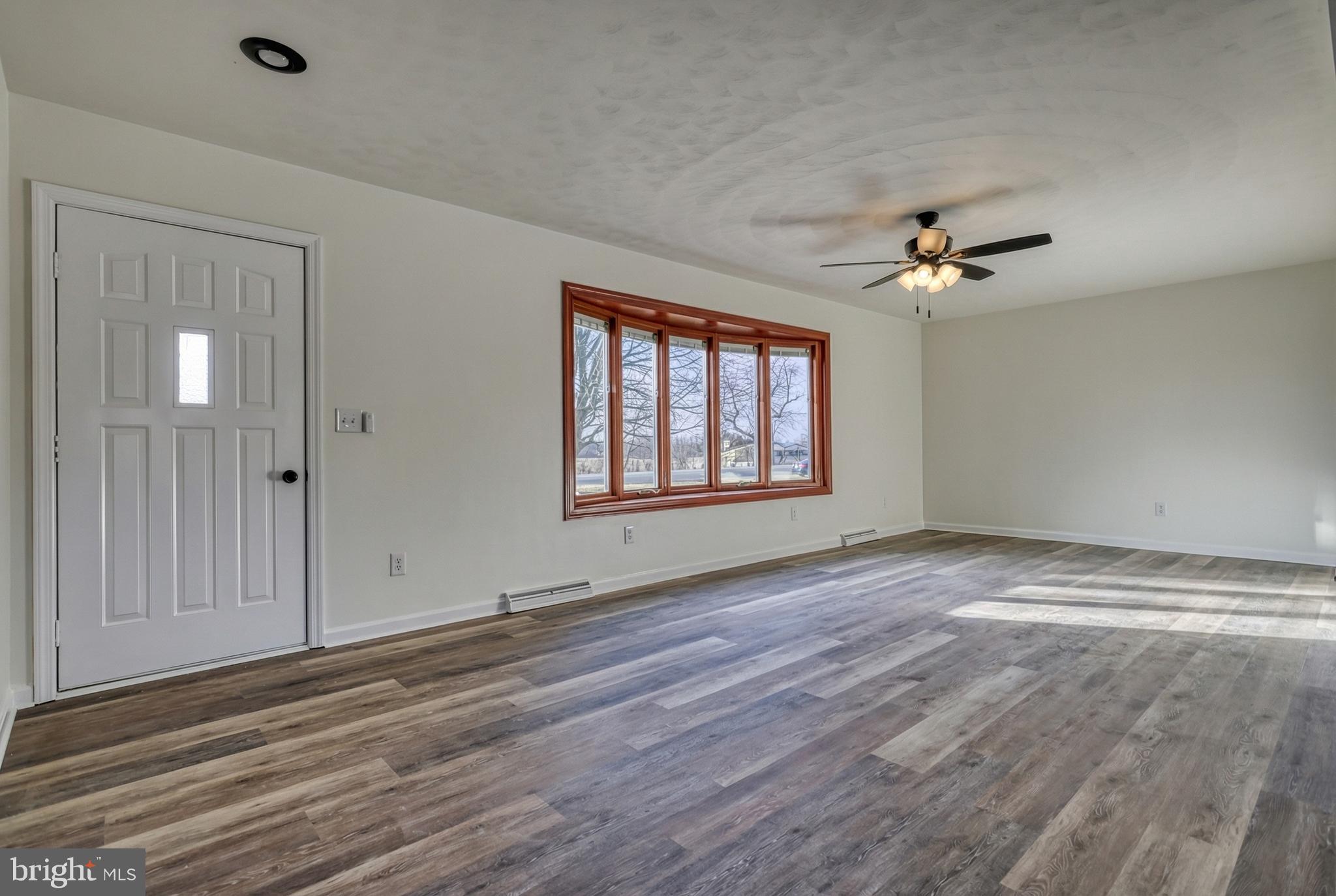79 North School House Road Thomasville, PA 17364 - Photo 8 of 73 a view of empty room with wooden floor and fan
