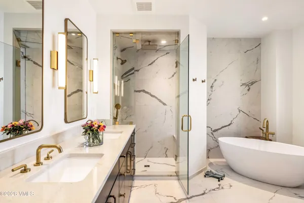 a bathroom with a granite countertop sink mirror and shower