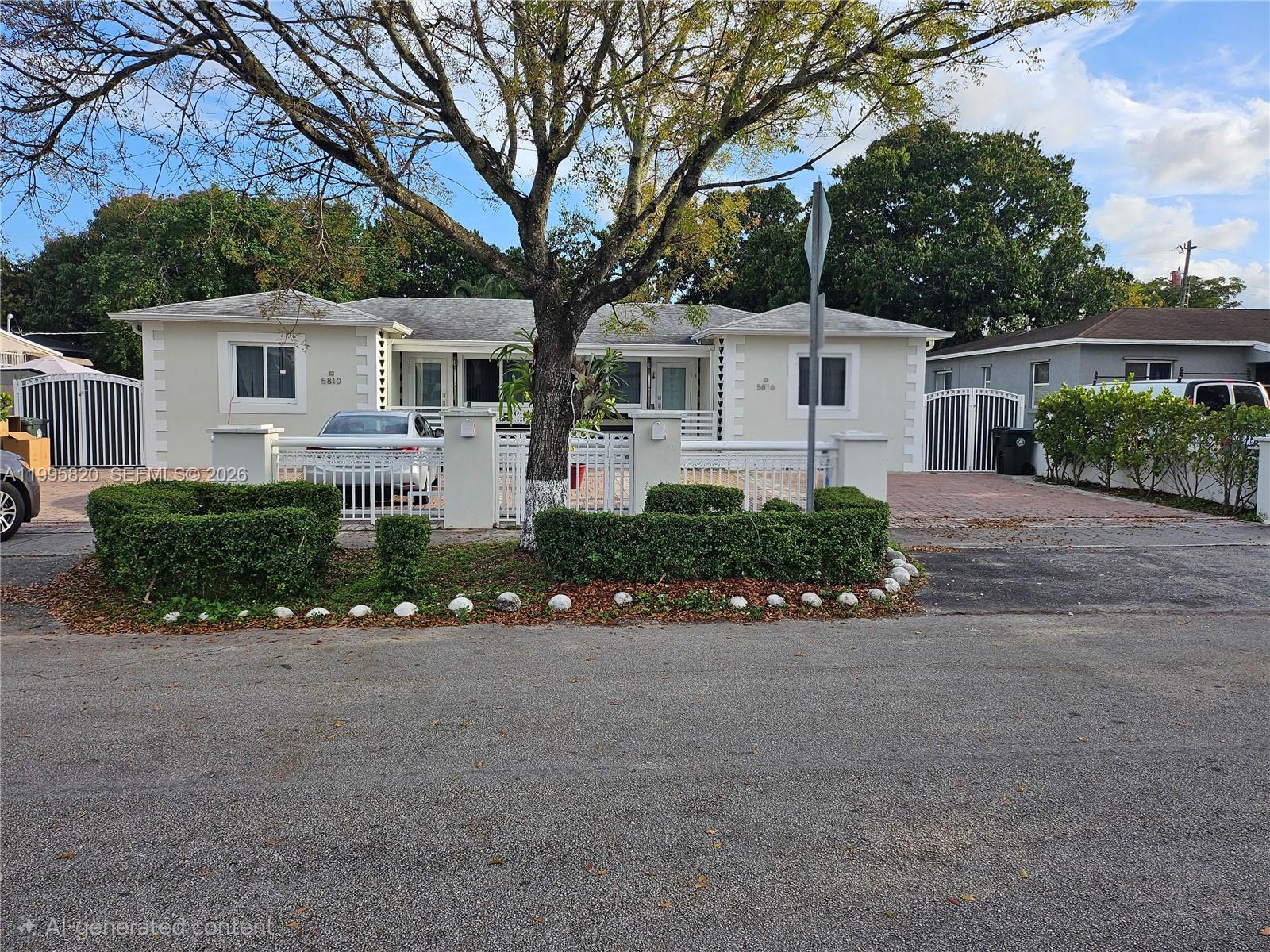 5816 Southwest 9th Street West Miami, FL 33144 - Photo 2 of 12 a front view of a house with a garden