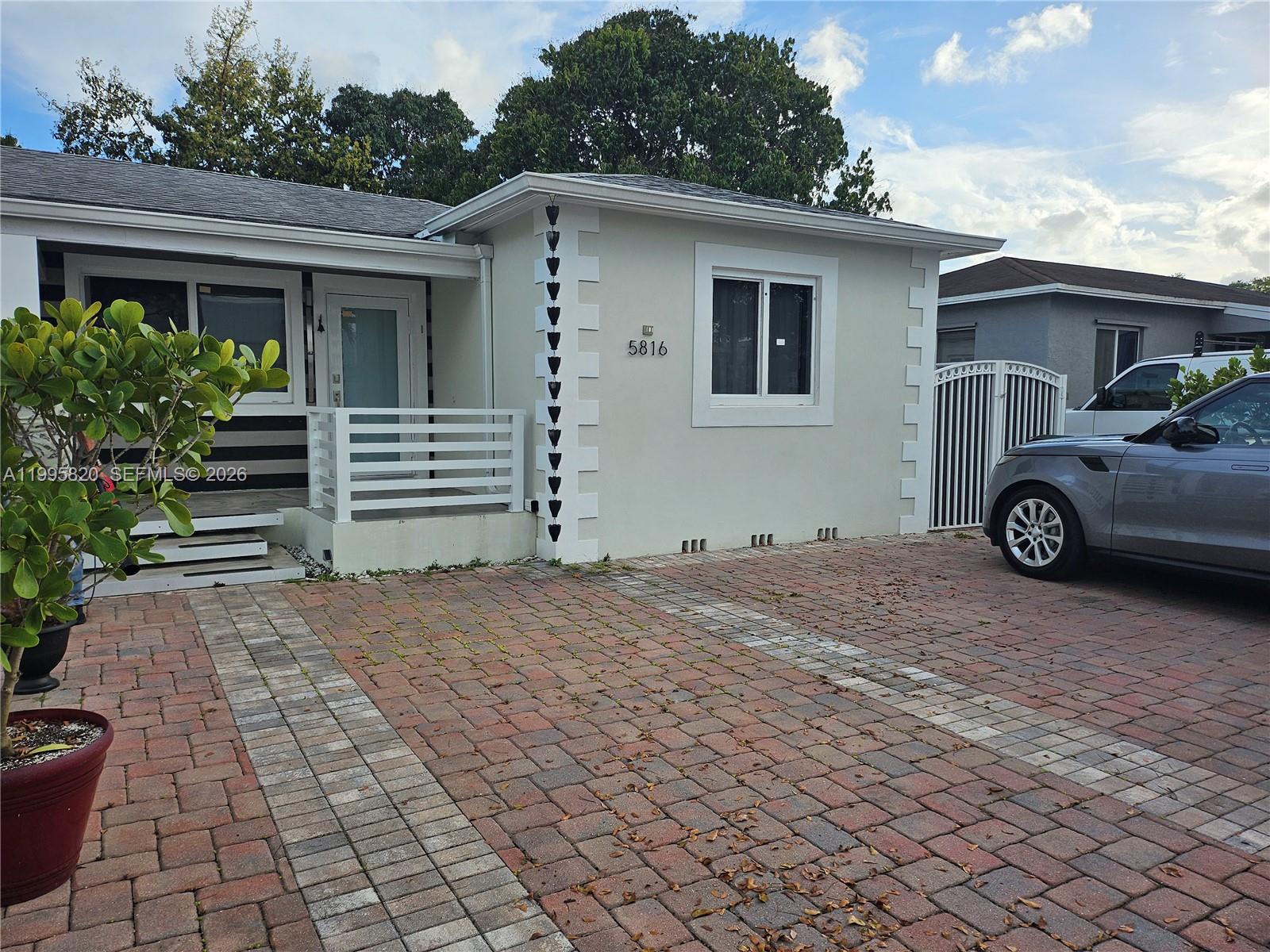 5816 Southwest 9th Street West Miami, FL 33144 - Photo 3 of 12 a front view of a house with parking space