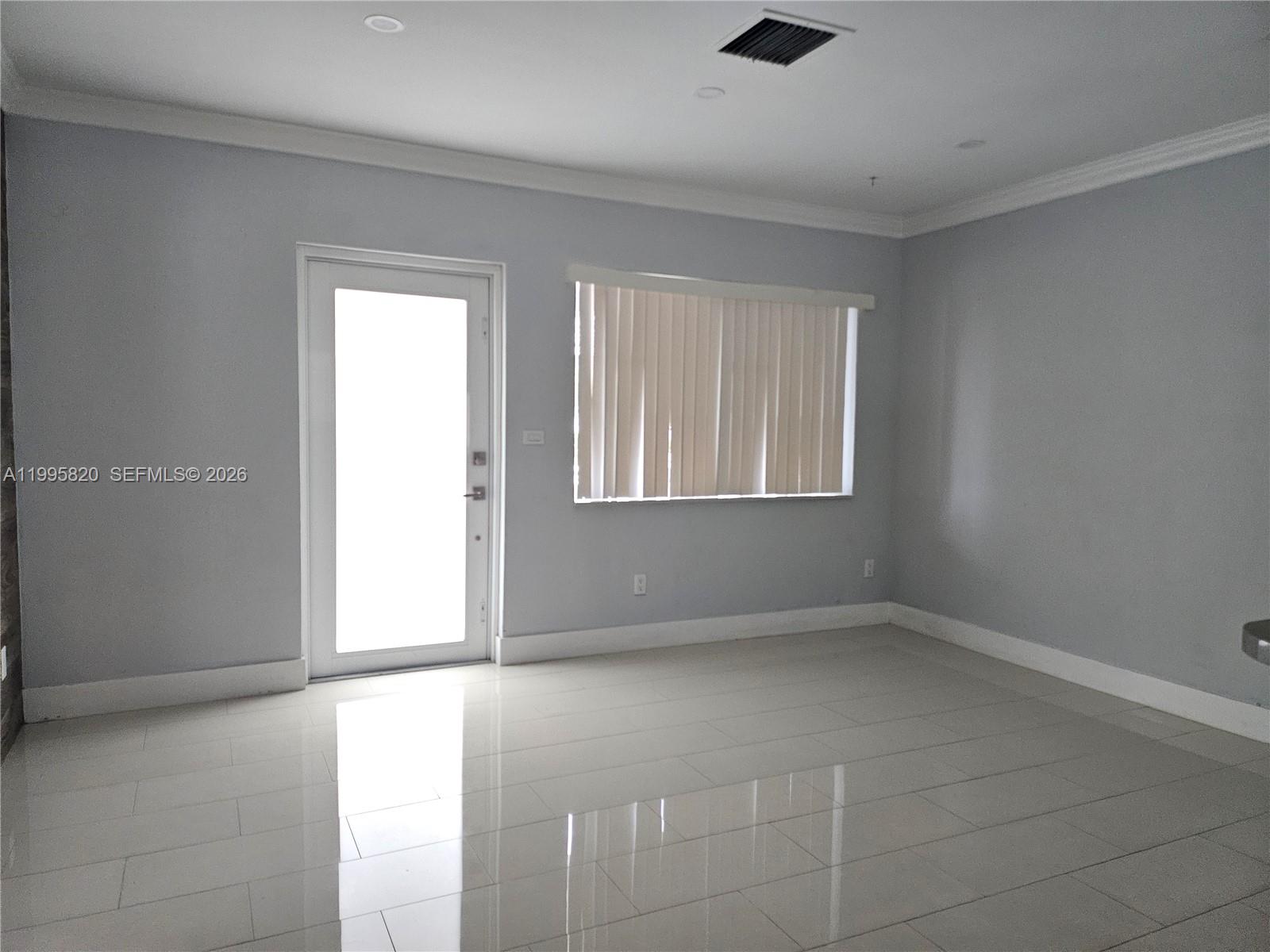 5816 Southwest 9th Street West Miami, FL 33144 - Photo 4 of 12 an empty room with windows