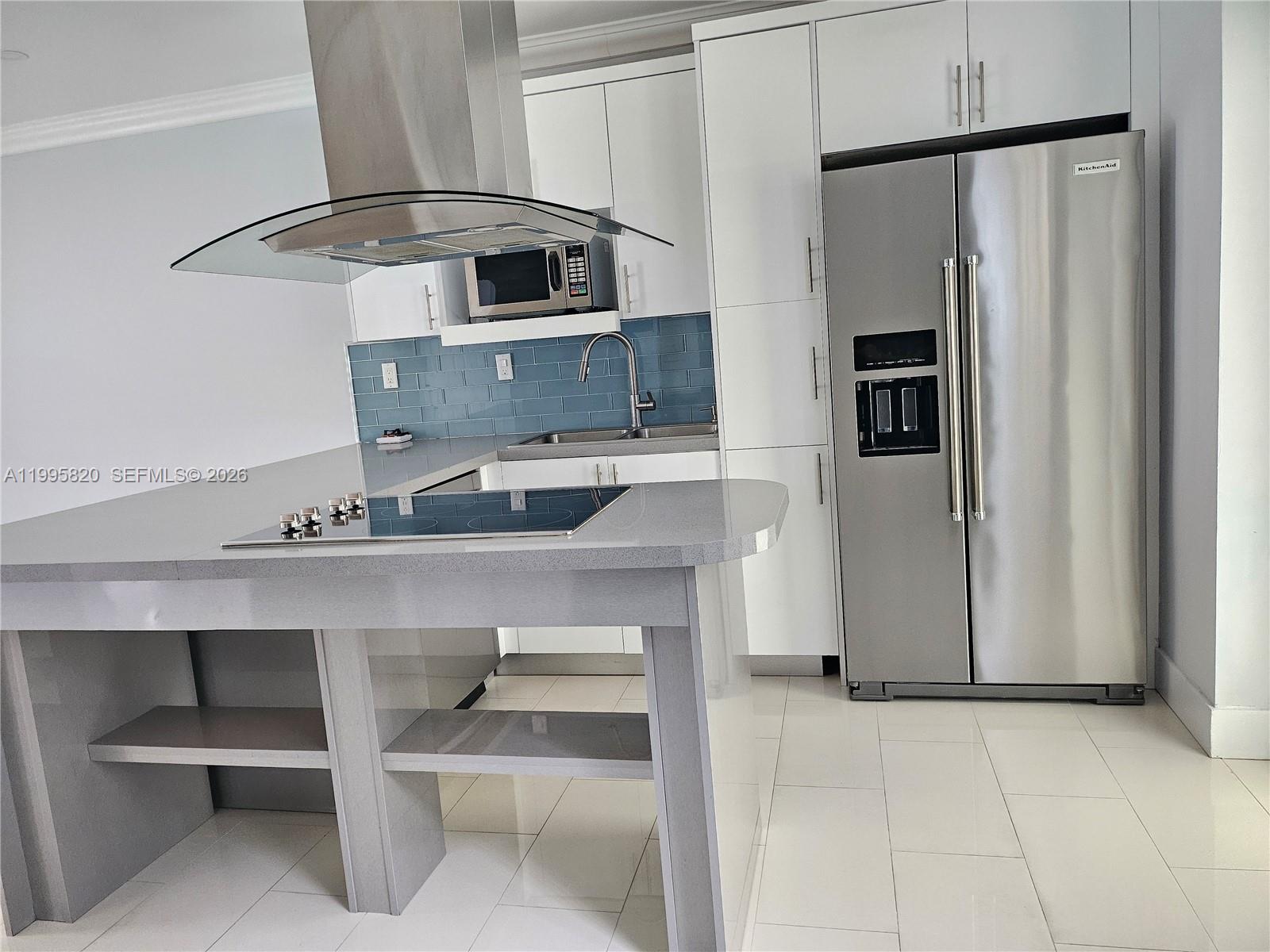 5816 Southwest 9th Street West Miami, FL 33144 - Photo 7 of 12 a kitchen with stainless steel appliances a refrigerator and a stove