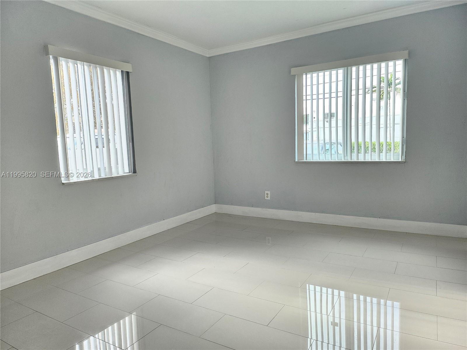 5816 Southwest 9th Street West Miami, FL 33144 - Photo 8 of 12 an empty room with a window