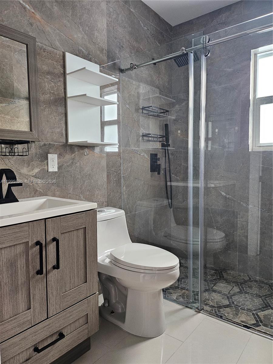 5816 Southwest 9th Street West Miami, FL 33144 - Photo 9 of 12 a bathroom with a sink toilet and shower