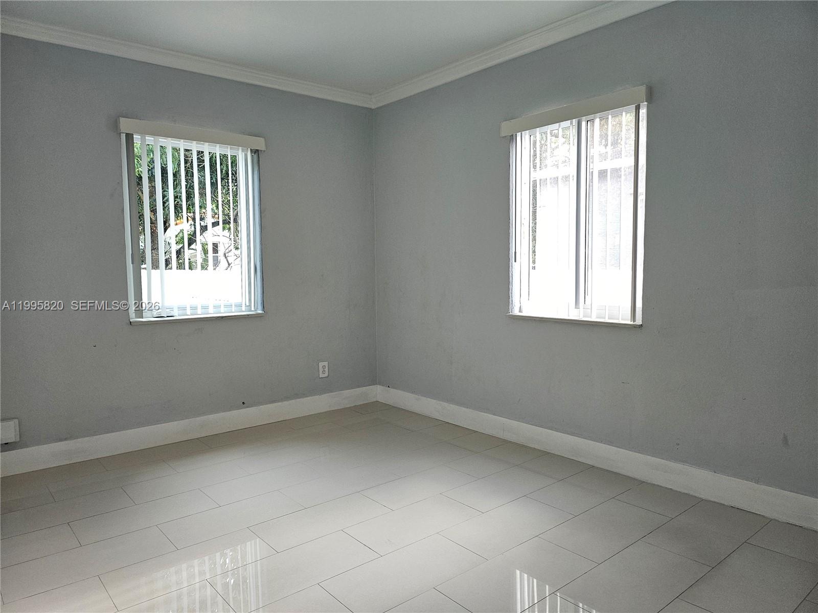 5816 Southwest 9th Street West Miami, FL 33144 - Photo 10 of 12 an empty room with a window