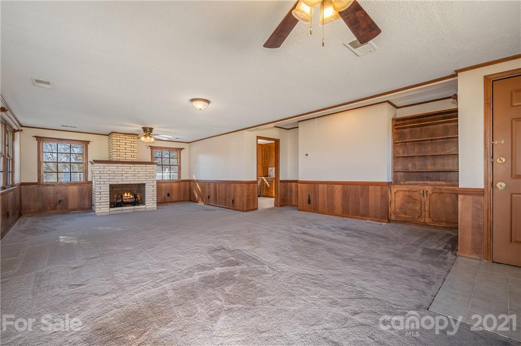 285 Tanner Street Rutherfordton, NC 28139 - Photo 13 of 39 a view of an empty room with a fireplace and window