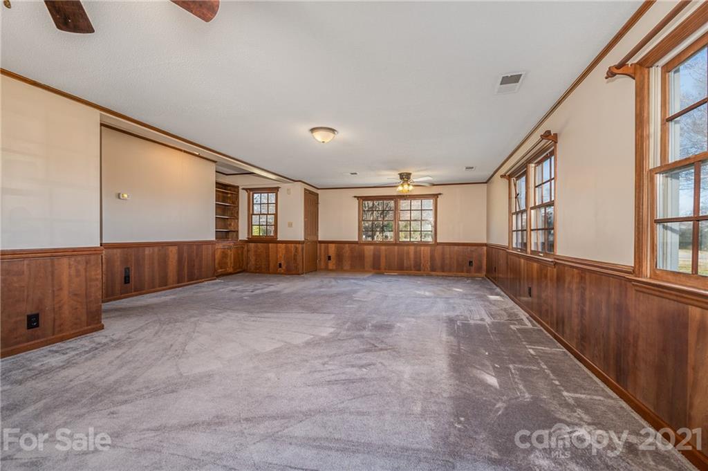 285 Tanner Street Rutherfordton, NC 28139 - Photo 14 of 39 a view of an empty room with wooden floor and stairs
