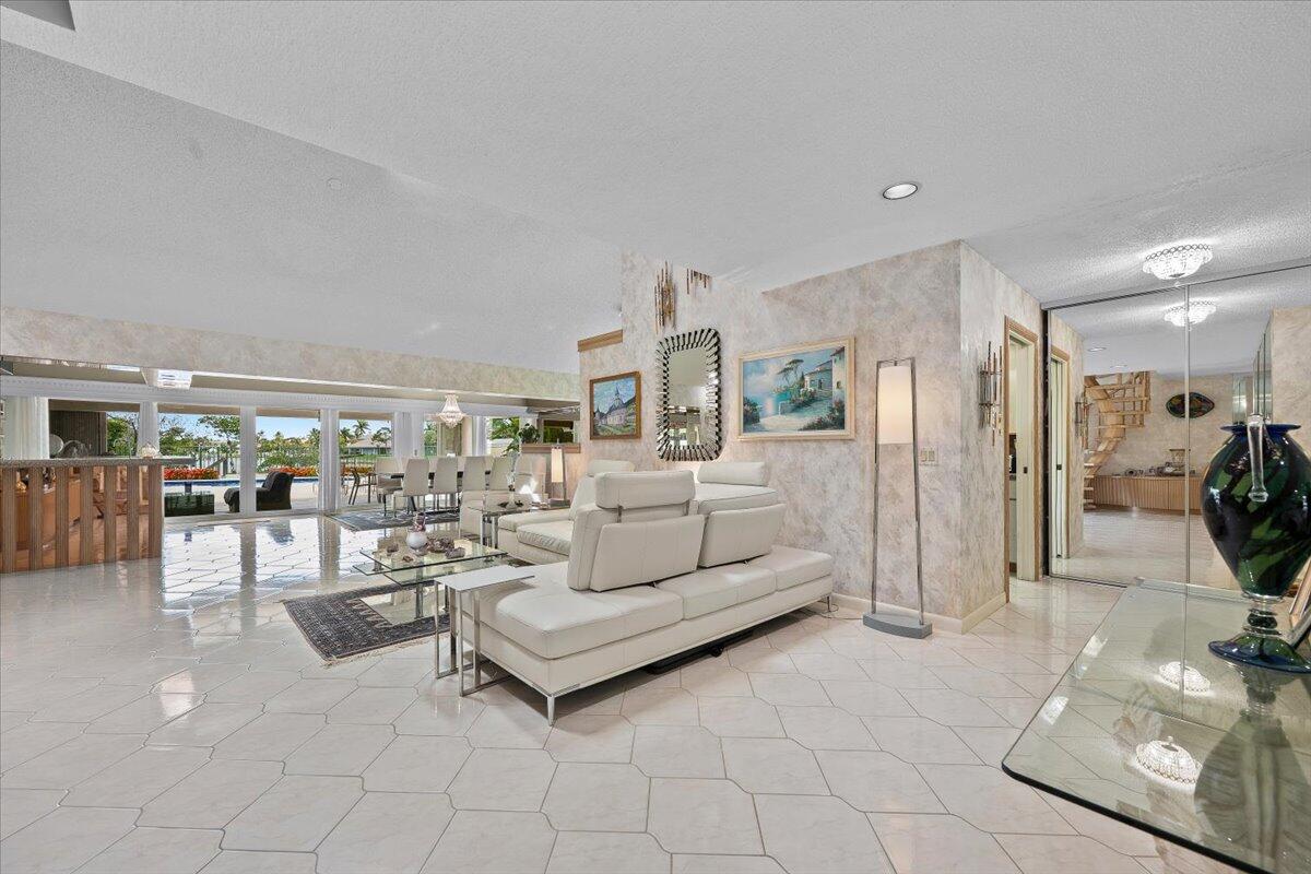 352 River Edge Road Jupiter, FL 33477 - Photo 4 of 56 a living room with furniture and a flat screen tv