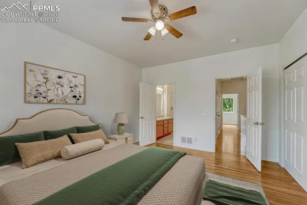 a bedroom with a large bed and a chandelier