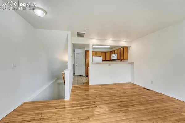 an empty room with a window and a ceiling fan
