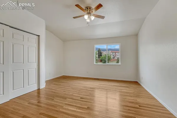 a view of empty room with wooden floor