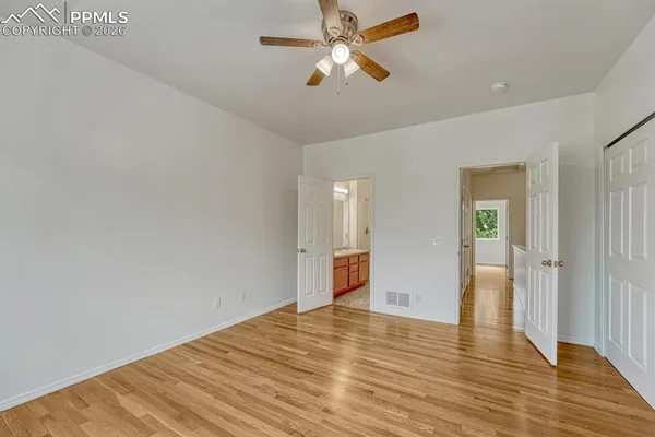 a view of empty room with wooden floor