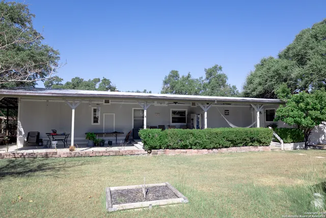 a backyard of a house with yard and outdoor seating