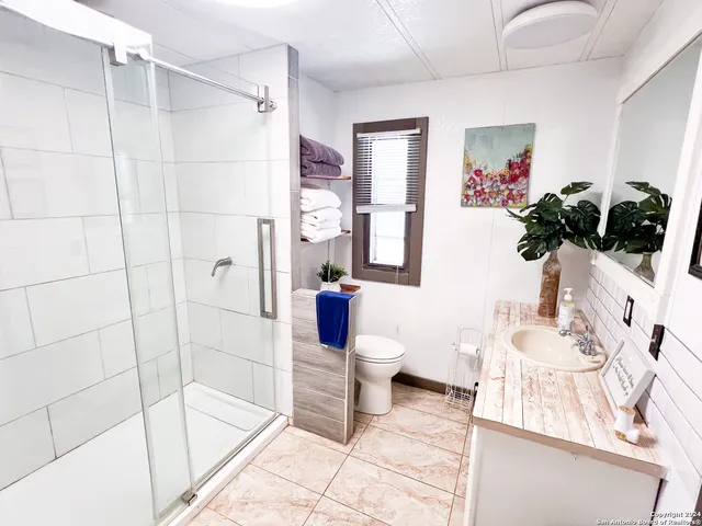 a bathroom with a sink toilet and shower