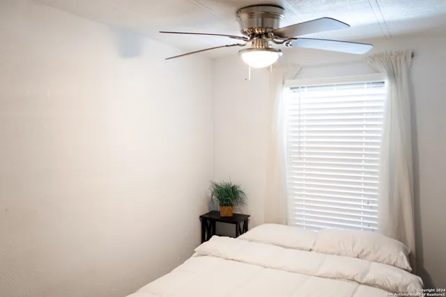 a bedroom with a bed and a window