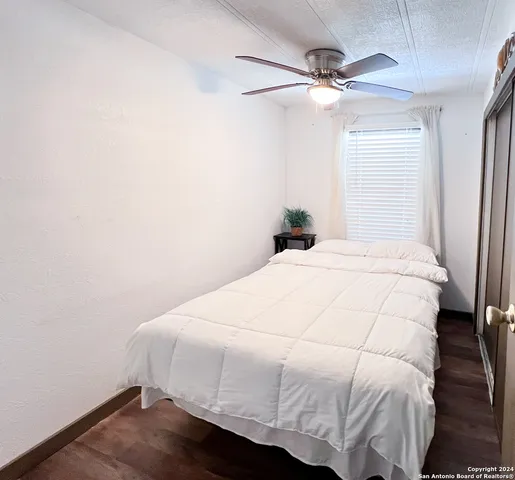 a bedroom with a bed and a ceiling fan
