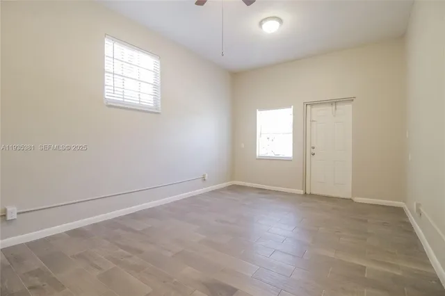 an empty room with windows and closet