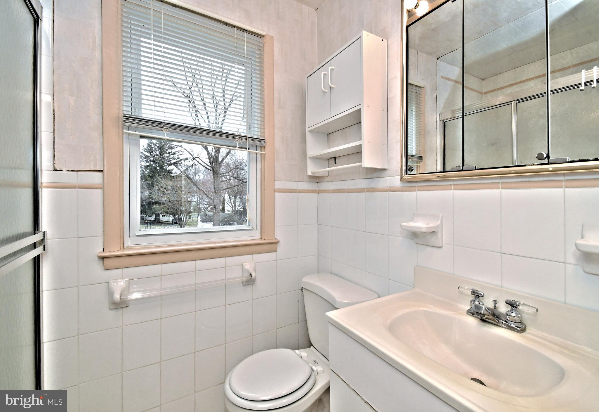 1658 Cavan Drive Dresher, PA 19025 - Photo 15 of 25 a bathroom with a sink a toilet and a window