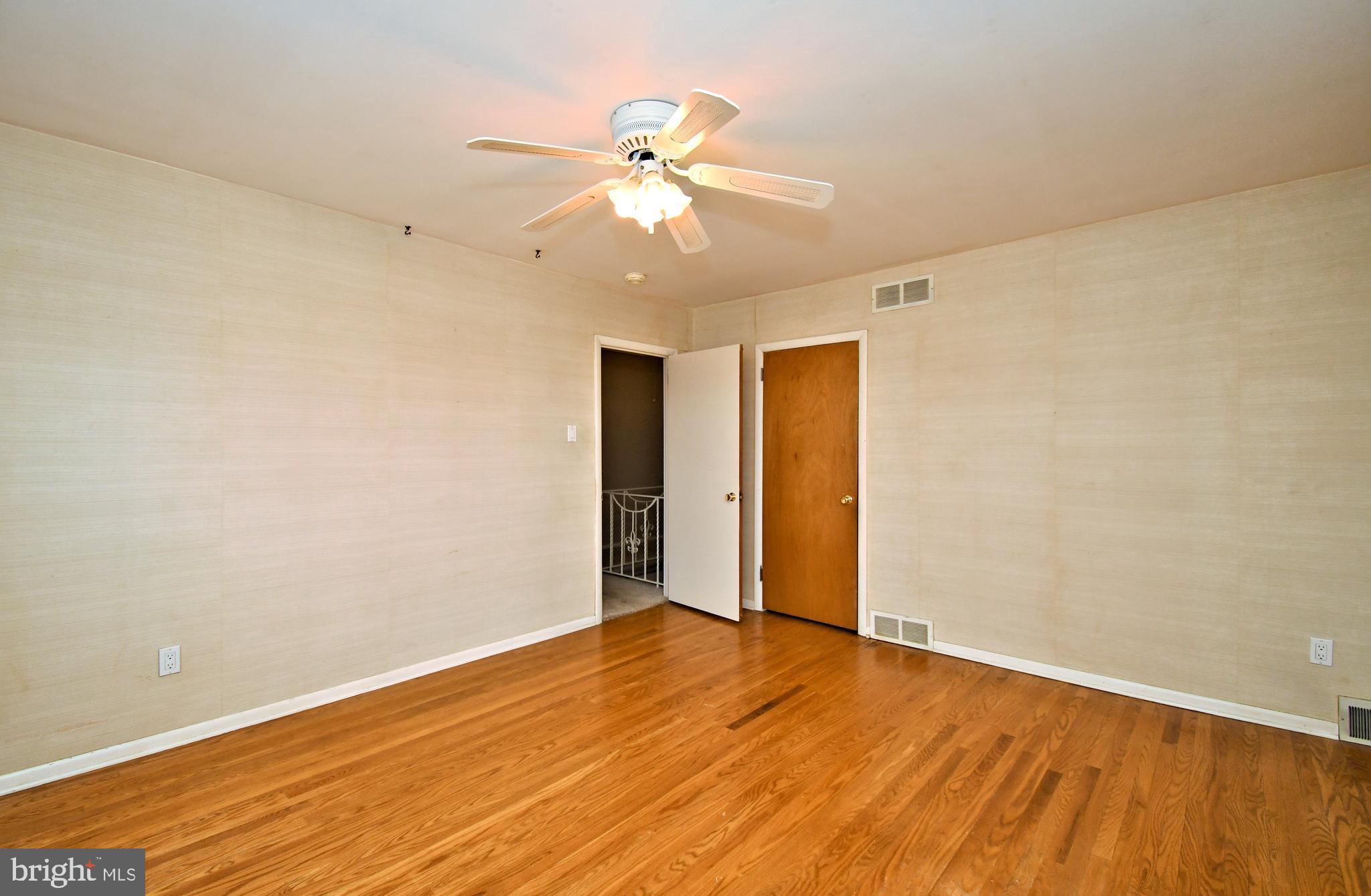 1658 Cavan Drive Dresher, PA 19025 - Photo 17 of 25 a view of an empty room with wooden floor and a ceiling fan