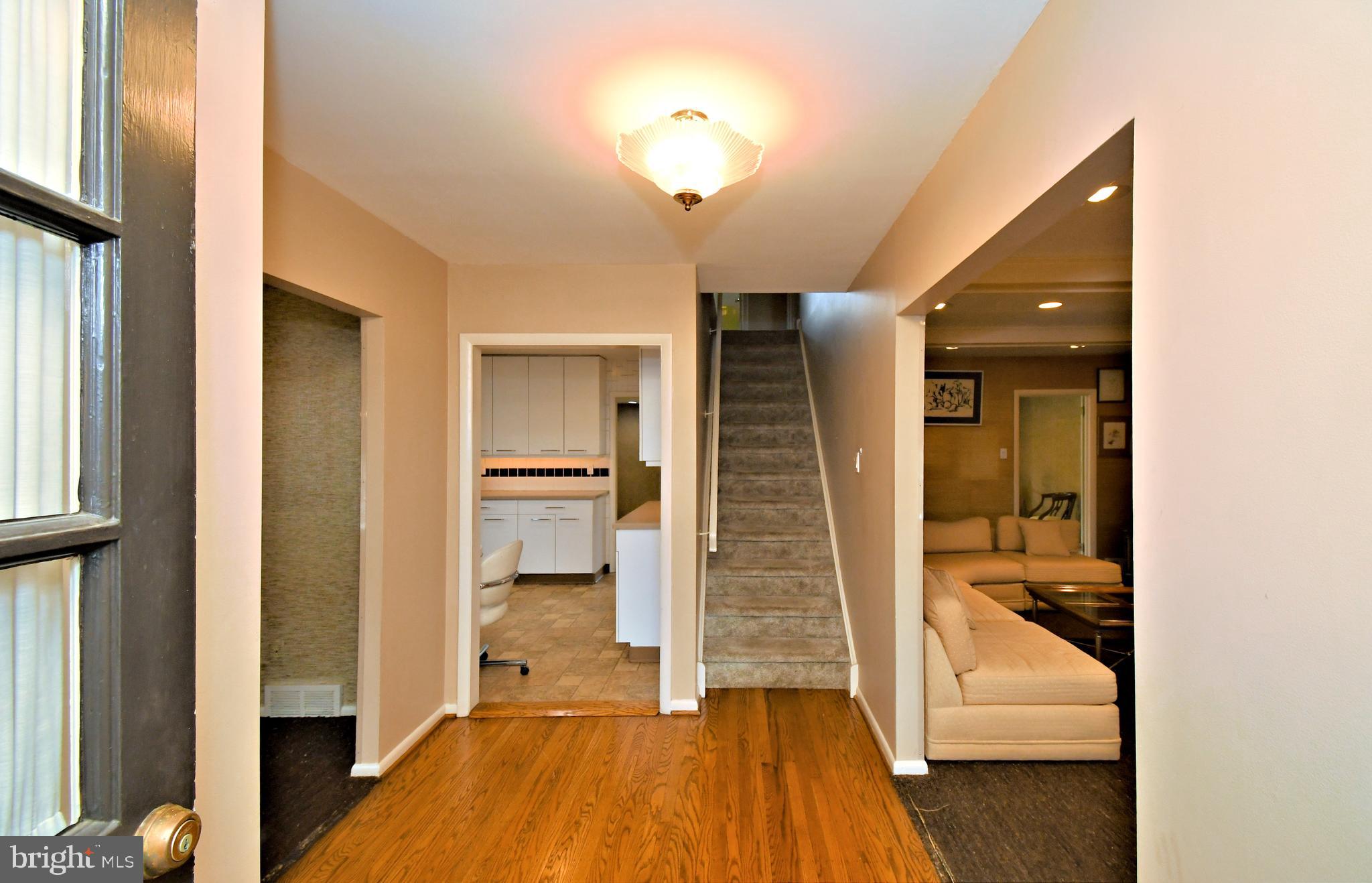 1658 Cavan Drive Dresher, PA 19025 - Photo 2 of 25 a view of a hallway with wooden floor and staircase