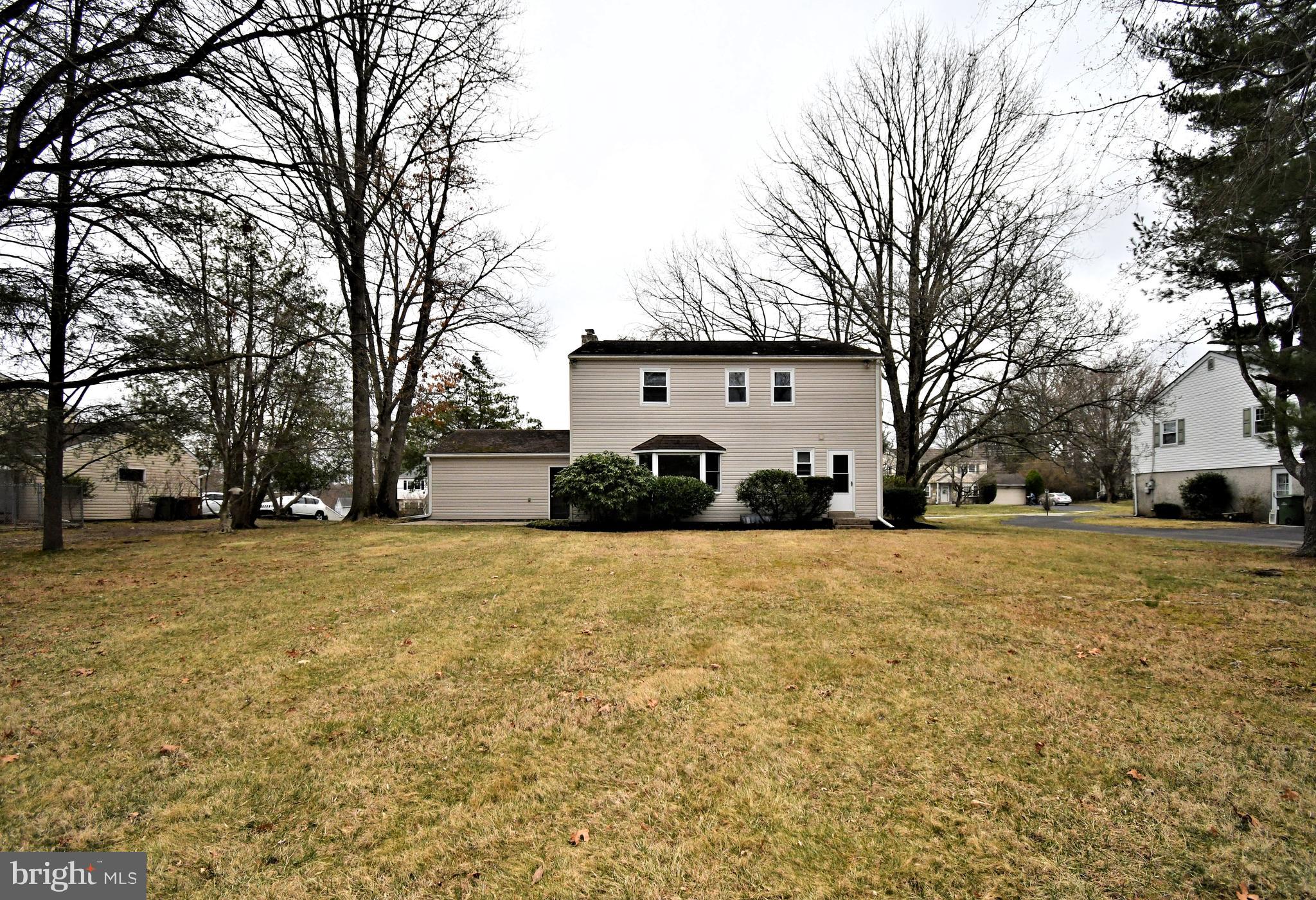 1658 Cavan Drive Dresher, PA 19025 - Photo 23 of 25 a front view of a house with a yard covered with snow and trees