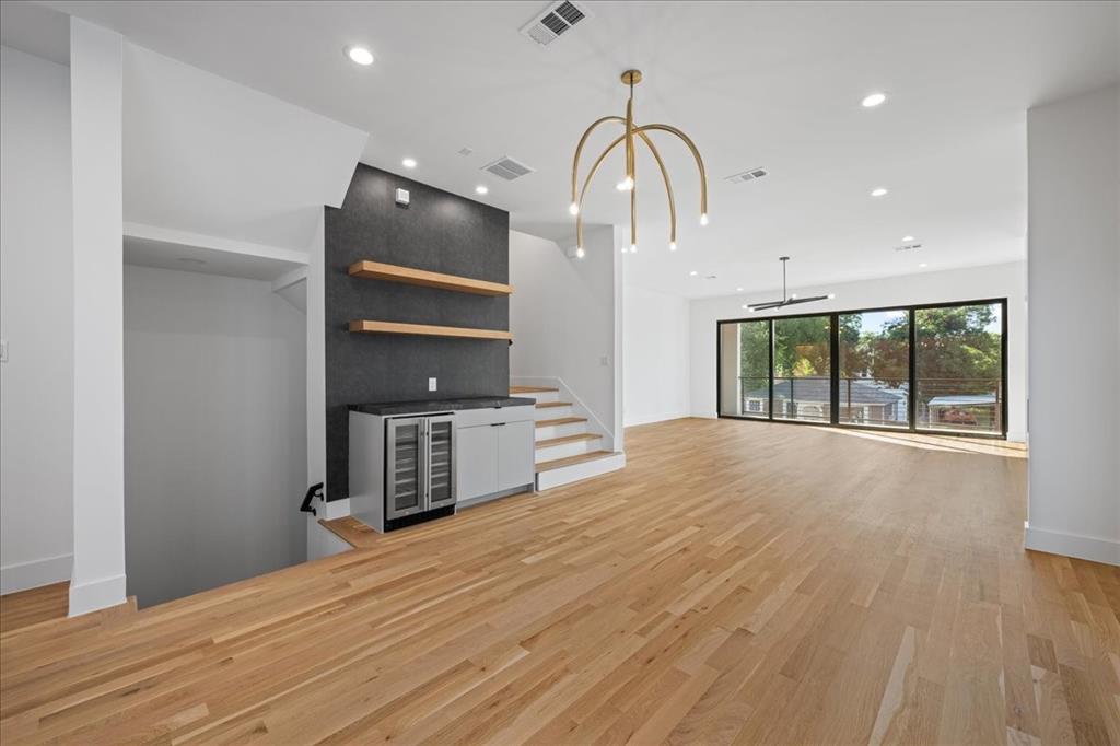 4517 Weldon Street Dallas, TX 75204 - Photo 15 of 40 a room with a bed and wooden floor