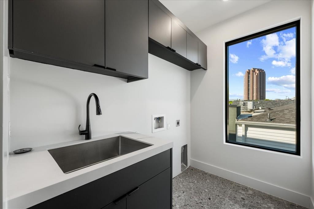 4517 Weldon Street Dallas, TX 75204 - Photo 19 of 40 a kitchen with a refrigerator and a sink
