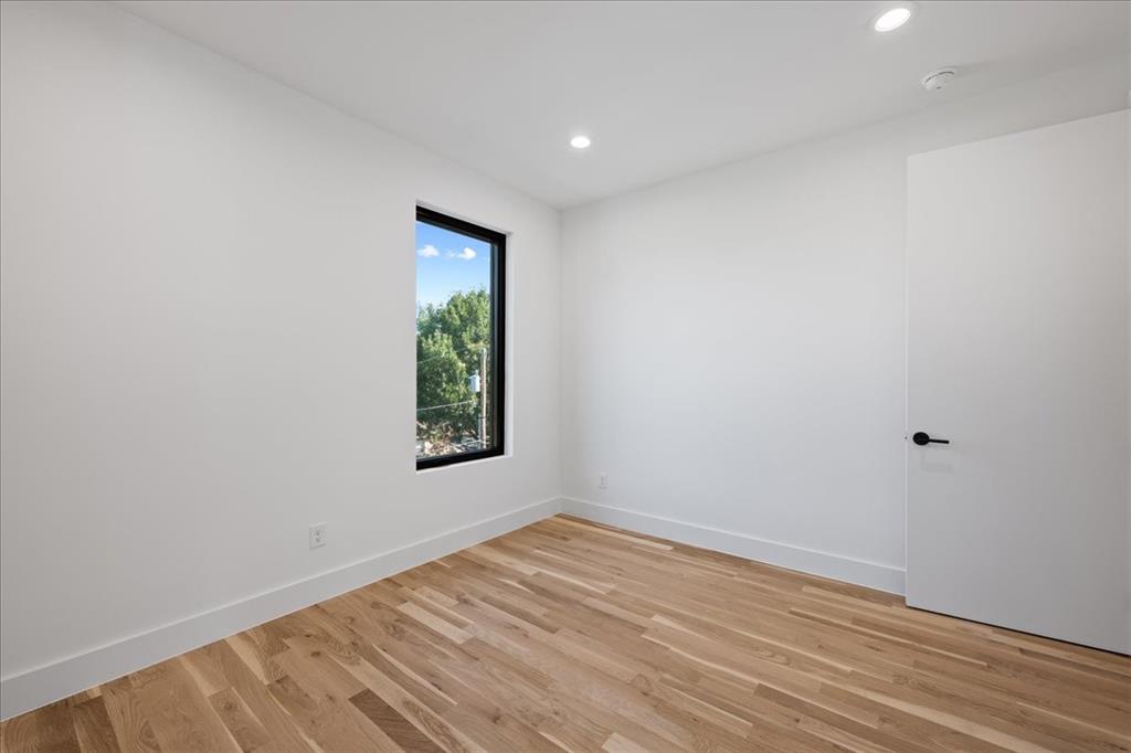 4517 Weldon Street Dallas, TX 75204 - Photo 21 of 40 a view of an empty room with wooden floor and a window