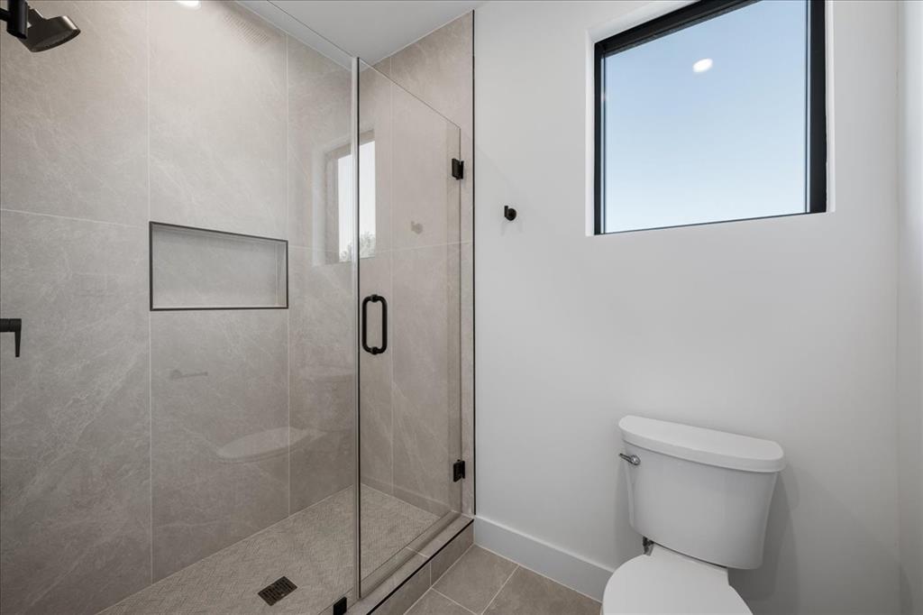 4517 Weldon Street Dallas, TX 75204 - Photo 23 of 40 a bathroom with a toilet and a shower