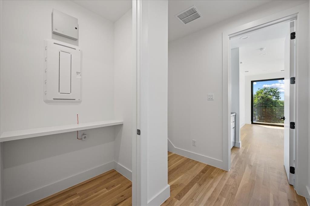 4517 Weldon Street Dallas, TX 75204 - Photo 26 of 40 a view of a hallway with wooden floor and closet