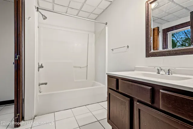 a bathroom with a sink a mirror and a bathtub