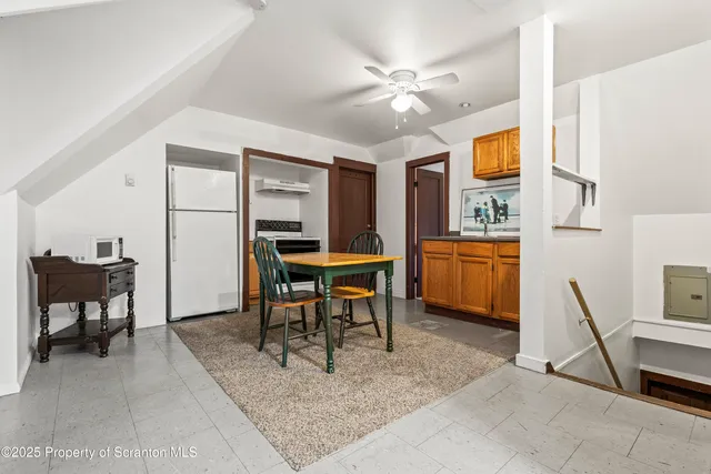 a view of a livingroom with furniture and a dining table