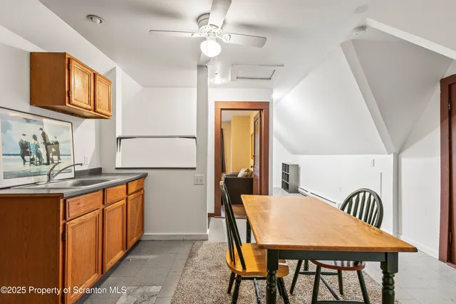 a view of a kitchen area with furniture and wooden floor