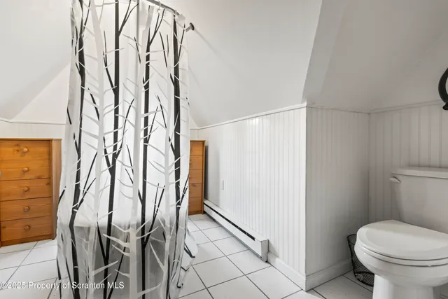 a bathroom with a toilet and shower