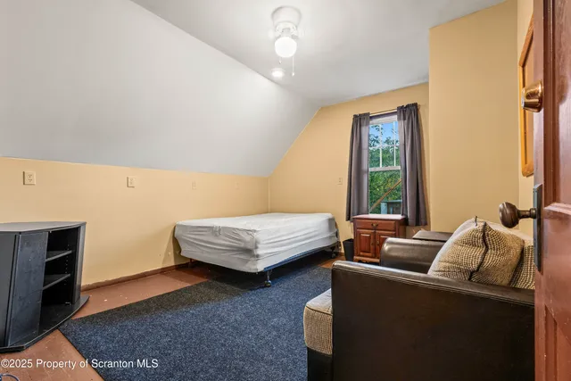 a bedroom with furniture and a window