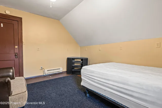 a bedroom with a bed and chair