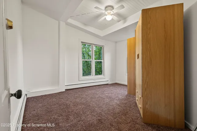 a view of empty room with a ceiling fan and a window