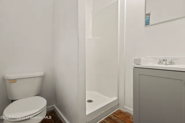 a white toilet sitting next to a bathroom sink